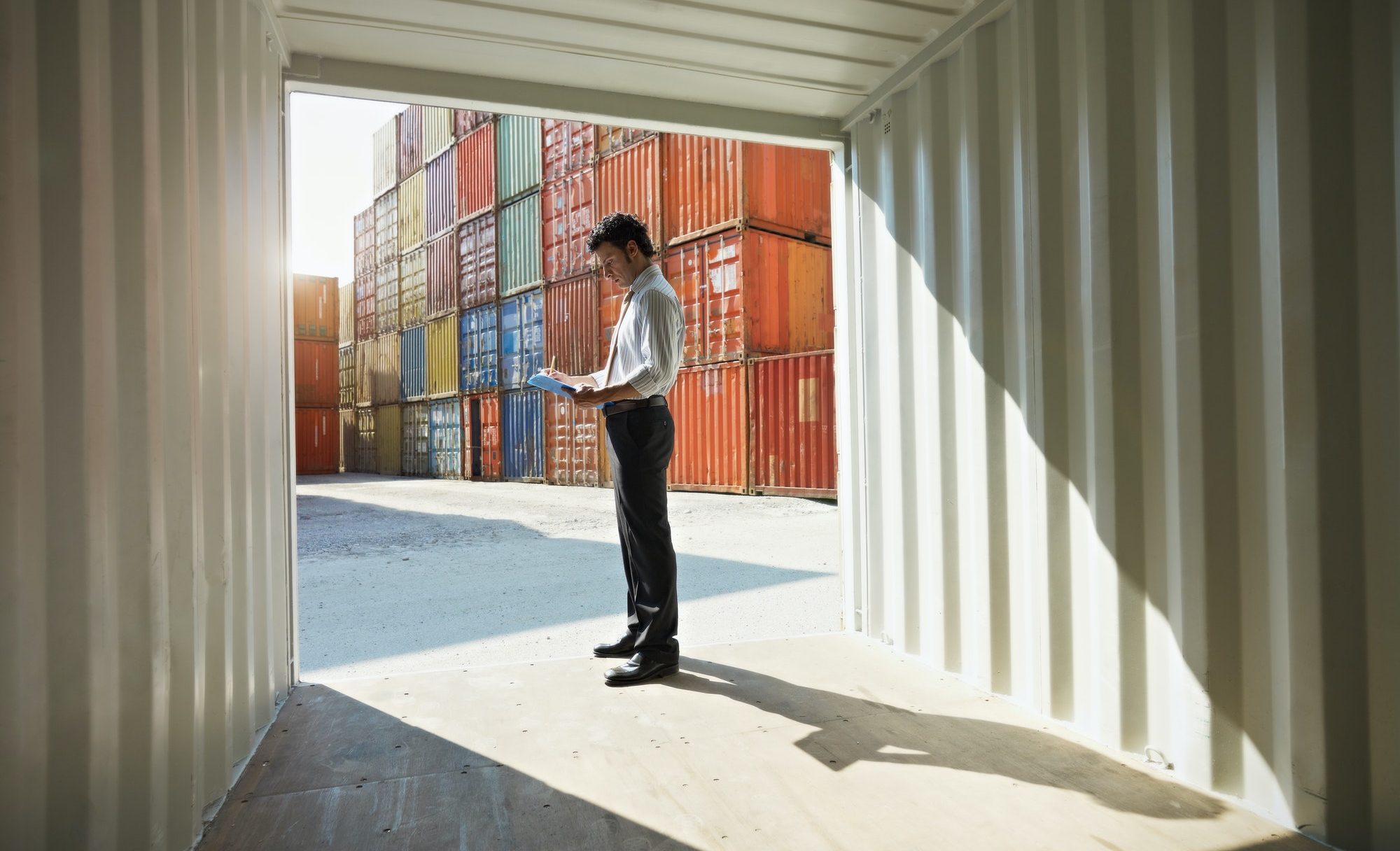 business man with shipping containers